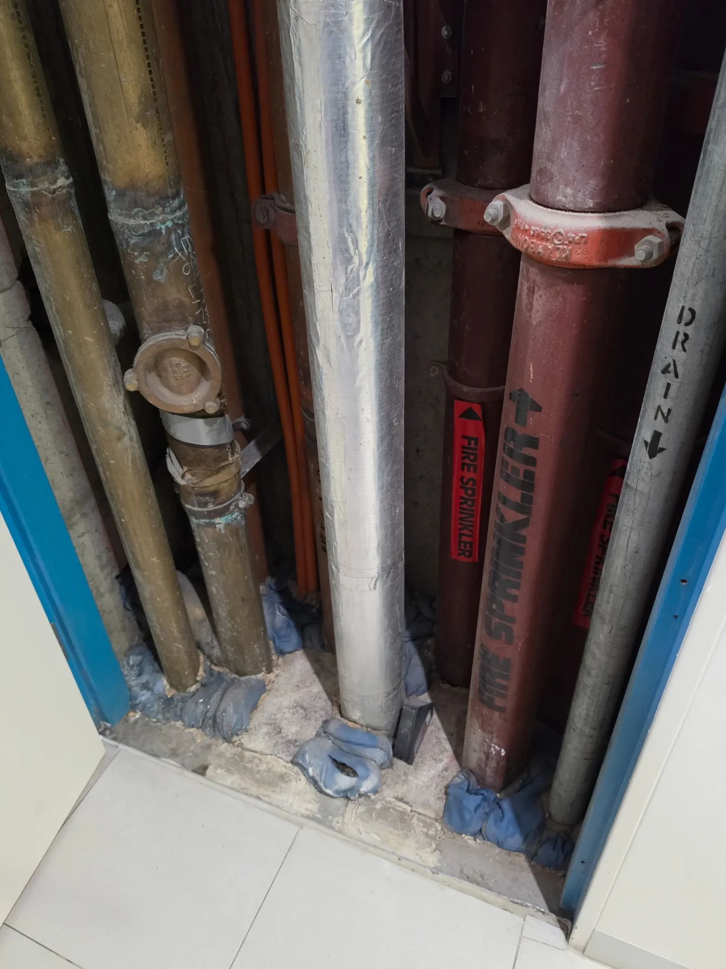 Sealed and repaired service pipework inside a hydraulic riser cupboard